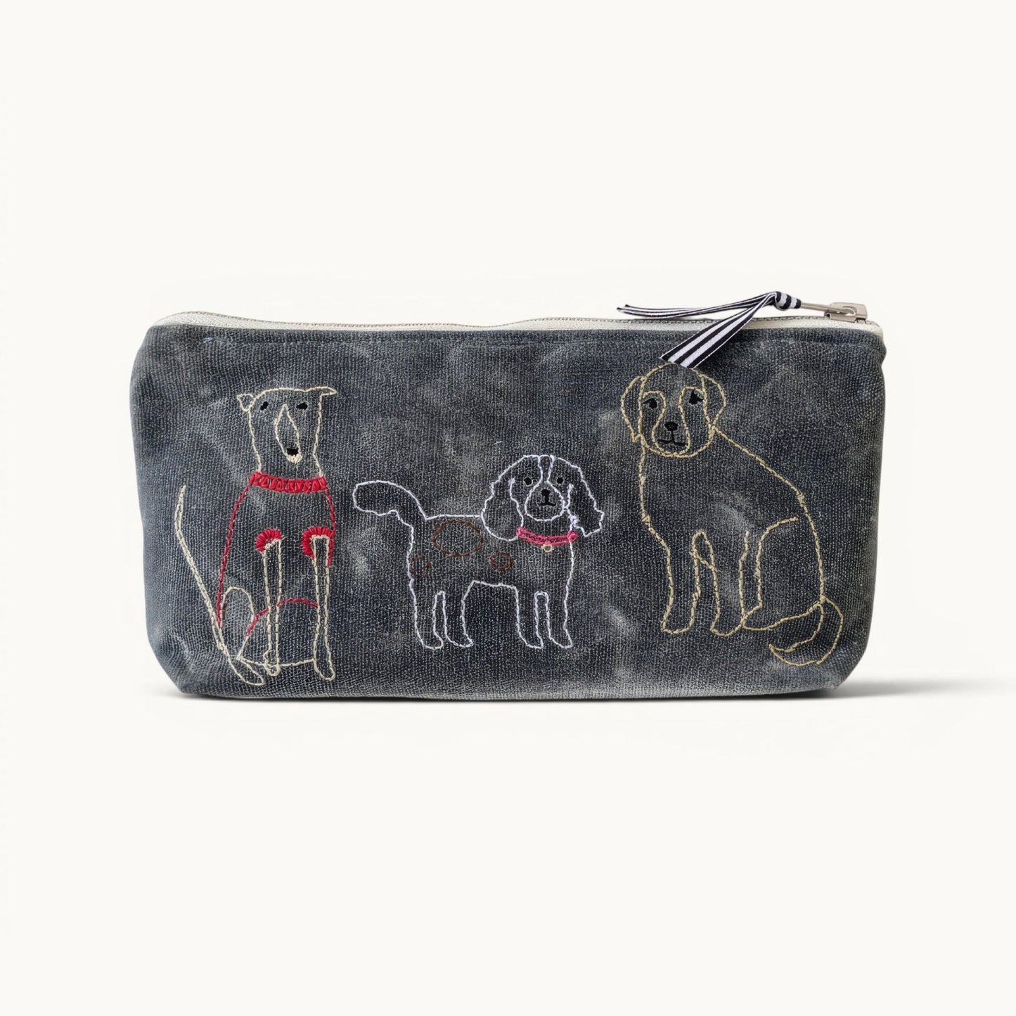 A rectangular zippered pouch in dark gray denim-like fabric, featuring embroidered dog illustrations in white, yellow, and red on the front, with a striped zipper pull.
