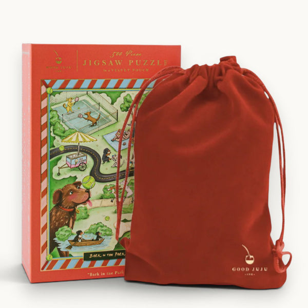 Jigsaw puzzle box with a red drawstring bag on a white background