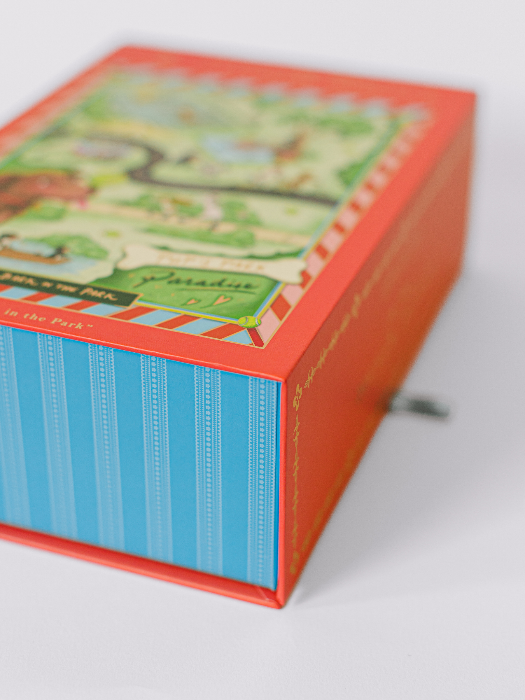 500-piece dog jigsaw puzzle with playful pups and gold foil accents in a magnetic keepsake box