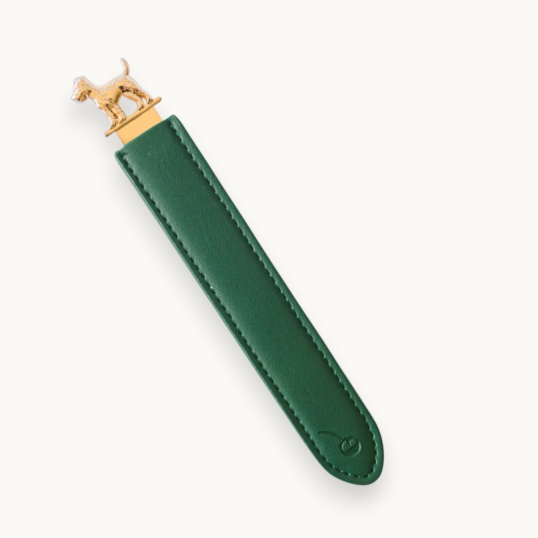 Polished metal dog-shaped bookmark and letter opener with vegan leather sleeve in foil-stamped gift box