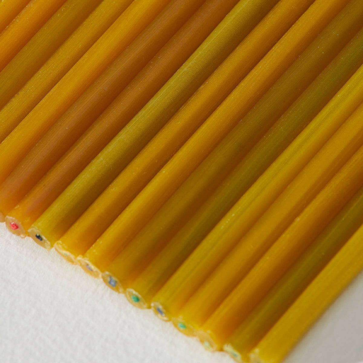 Close-up of beeswax candles on a light background.