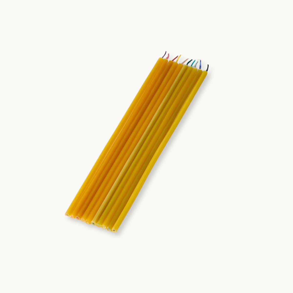 Set of 10 slim beeswax candles in yon a light background.