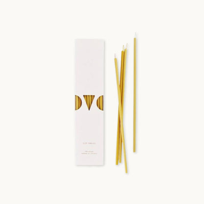 Set of slim beeswax candles with a white box featuring 'OVO' branding on a white background.