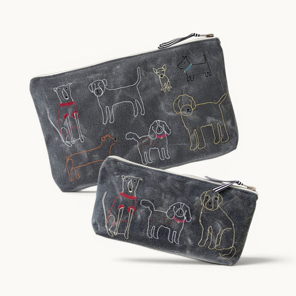 Two dark gray zippered pouches with embroidered dog illustrations, displayed on a clean off-white background.