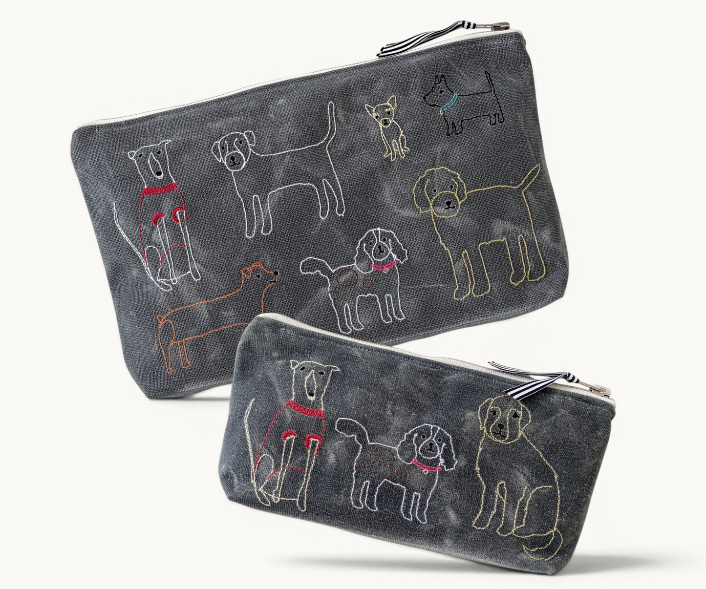 Two dark grey pouches with embroidered dog illustrations