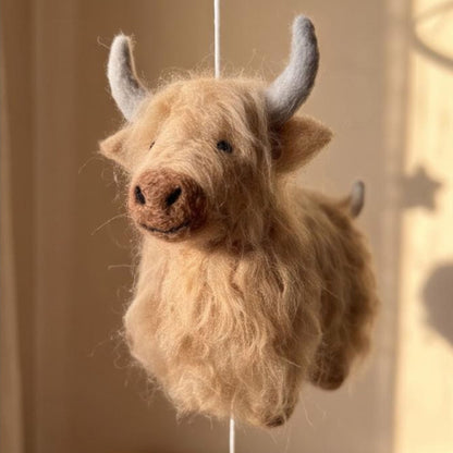 Handcrafted Highland cow felt baby mobile featuring fluffy cow in tan.