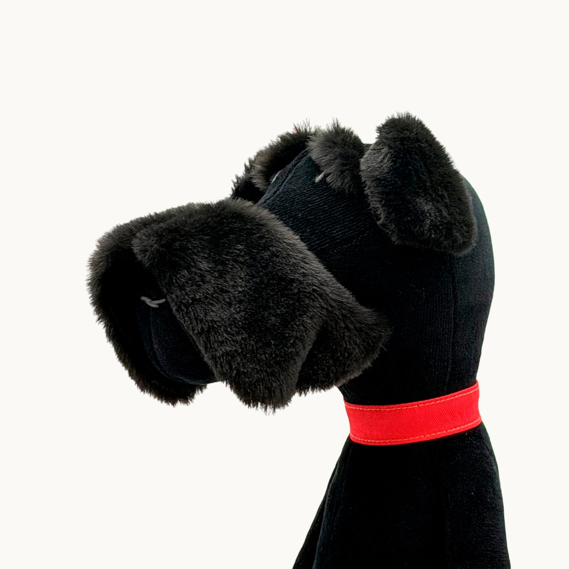 Sascha the Schnauzer from children's picture book dog+girl black dog toy with a red collar on a white background.Sascha plush. dog+girl plush. plush dog. stuffed animal.