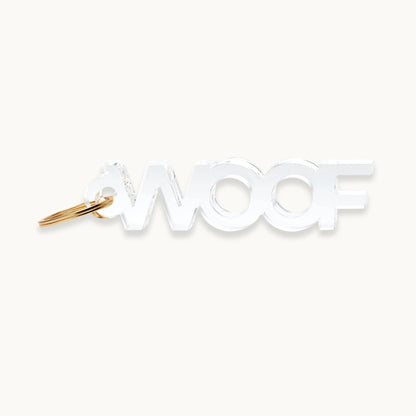 Clear 'WOOF' dog acrylic keychain with gold key ring.